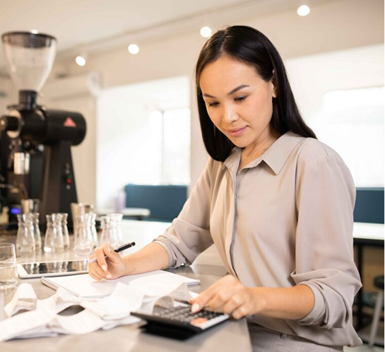 Woman reviewing invoices and bookkeeping paperwork.