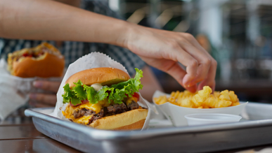 Hamburger and fries on a tray.